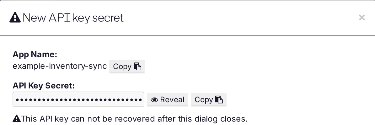 The New API key secret window with the masked secret and the Reveal and Copy buttons